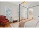 Light-filled bedroom featuring a four-poster bed and stylish decor at 305 N Civitas St, Mount Pleasant, SC 29464