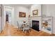 Cozy dining area featuring a fireplace, wood floors, and ample natural light. Perfect for intimate meals at 305 N Civitas St, Mount Pleasant, SC 29464