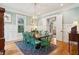 Elegant dining room with wainscoting, hardwood floors, and a stylish chandelier, ideal for entertaining at 305 N Civitas St, Mount Pleasant, SC 29464