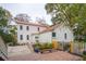 Charming home exterior featuring a red roof, lush landscaping, and a brick pathway at 305 N Civitas St, Mount Pleasant, SC 29464