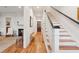Bright hallway with wooden floors, staircase, fireplace, and stylish decor at 305 N Civitas St, Mount Pleasant, SC 29464