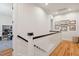 Upstairs hallway with hardwood floors and decorative artwork on the wall at 305 N Civitas St, Mount Pleasant, SC 29464