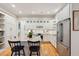 Bright kitchen featuring white cabinets, granite countertops, stainless steel appliances, and wooden floors at 305 N Civitas St, Mount Pleasant, SC 29464
