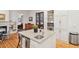 Bright kitchen featuring white cabinets, granite countertops, stainless steel appliances, and island sink at 305 N Civitas St, Mount Pleasant, SC 29464