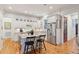 Spacious kitchen featuring white cabinetry, granite countertops, stainless steel appliances, and wooden floors at 305 N Civitas St, Mount Pleasant, SC 29464