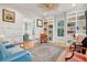 Bright living room with hardwood floors, custom built-in shelving, and cozy seating at 305 N Civitas St, Mount Pleasant, SC 29464