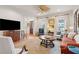 Bright living room with hardwood floors, area rug, ceiling fan, comfortable seating, and natural light at 305 N Civitas St, Mount Pleasant, SC 29464