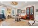 Bright living room featuring a ceiling fan, hardwood floors, and comfortable seating at 305 N Civitas St, Mount Pleasant, SC 29464