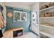 Charming mudroom with built-in bench, storage, and natural light from the window at 305 N Civitas St, Mount Pleasant, SC 29464