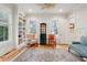 Sunlit office with built-in bookshelves, natural light, and a stylish area rug, perfect for working from home at 305 N Civitas St, Mount Pleasant, SC 29464