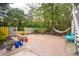 Inviting brick patio with a cozy seating area, mature trees, and a relaxing hammock at 305 N Civitas St, Mount Pleasant, SC 29464