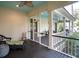 Charming screened porch with dark floors, a blue ceiling, and cozy furniture at 305 N Civitas St, Mount Pleasant, SC 29464