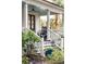 Inviting front porch with rocking chairs, overhead fan, and staircase leading to a wooden front door at 305 N Civitas St, Mount Pleasant, SC 29464