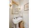 Elegant powder room with stylish fixtures, a decorative mirror, and classic design elements at 305 N Civitas St, Mount Pleasant, SC 29464