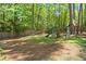 Spacious backyard featuring a playset, swing set, and mature trees at 309 Huntington Rd, Summerville, SC 29483