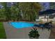 Sparkling backyard pool with lounge chairs and umbrella, perfect for relaxing on a summer evening at 309 Huntington Rd, Summerville, SC 29483