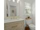 Stylish bathroom with a wood vanity, stone countertop, a large mirror, and decorative fixtures at 309 Huntington Rd, Summerville, SC 29483