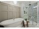 The bathroom showcases a freestanding tub and a luxurious tiled glass enclosed shower at 309 Huntington Rd, Summerville, SC 29483