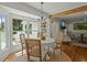Bright dining area with a round table, four chairs, and a large window overlooking the backyard at 309 Huntington Rd, Summerville, SC 29483