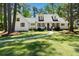 Charming white home with shuttered windows features a curved walkway leading to the front entrance at 309 Huntington Rd, Summerville, SC 29483