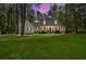 Charming white home with shuttered windows at twilight features a curved walkway leading to the front entrance at 309 Huntington Rd, Summerville, SC 29483
