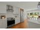 Updated kitchen presents stainless steel appliances, white cabinets, and open access to dining area at 309 Huntington Rd, Summerville, SC 29483