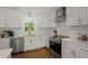 Modern kitchen offers white cabinets, stainless steel appliances, and subway tile backsplash at 309 Huntington Rd, Summerville, SC 29483