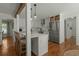 Charming kitchen featuring a breakfast bar, stainless steel appliances, white cabinetry, and hardwood floors at 309 Huntington Rd, Summerville, SC 29483