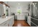 Bright kitchen with stainless steel appliances, white cabinets, and hardwood floors at 309 Huntington Rd, Summerville, SC 29483