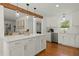 Stylish kitchen features white cabinets, hardwood floors, and an island with seating at 309 Huntington Rd, Summerville, SC 29483