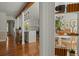 Open kitchen view with white cabinets, stainless steel appliances, and hardwood floors connecting to dining area at 309 Huntington Rd, Summerville, SC 29483