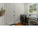 Bright laundry room featuring modern washer and dryer, ample counter space, and natural light at 309 Huntington Rd, Summerville, SC 29483