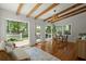 Bright living room with wood beam ceilings, hardwood floors, and an exit to the pool area at 309 Huntington Rd, Summerville, SC 29483