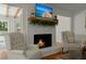 Charming living room presents a brick fireplace with a decorative mantle and hardwood floors at 309 Huntington Rd, Summerville, SC 29483