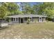 Inviting one-story home featuring a cozy porch and landscaped front yard at 3308 Comsee Ln, Johns Island, SC 29455