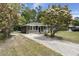 Lovely home with a long driveway and flourishing flowering trees at 3308 Comsee Ln, Johns Island, SC 29455