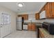 A functional kitchen featuring tile floors, granite counters, stainless steel appliances and wooden cabinetry at 3308 Comsee Ln, Johns Island, SC 29455