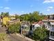 Scenic aerial view showcases the home's location near the Andrew Pinckney Inn, lush trees, and quaint street at 34 Pinckney St, Charleston, SC 29401