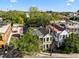 Aerial view showcases the property's rooftops, charming neighborhood, and lush surroundings at 34 Pinckney St, Charleston, SC 29401
