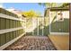 Private backyard with a mix of brick and wood accents, plus a green fence at 34 Pinckney St, Charleston, SC 29401
