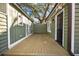 Backyard features a wood deck between green-painted sheds and a mature tree canopy above at 34 Pinckney St, Charleston, SC 29401