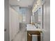 Bright bathroom with a white marble vanity, modern fixtures and tile flooring at 34 Pinckney St, Charleston, SC 29401