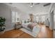 Inviting bedroom with a stone fireplace, hardwood floors and a ceiling fan at 34 Pinckney St, Charleston, SC 29401