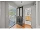 Entryway leading to a porch and bathroom, showcasing hardwood floors at 34 Pinckney St, Charleston, SC 29401