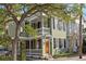Charming two-story home with a porch, balcony, light green siding, and black shutters at 34 Pinckney St, Charleston, SC 29401