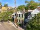 Charming two-story home with a light green exterior, complemented by lush landscaping and a private driveway at 34 Pinckney St, Charleston, SC 29401