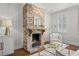 Living room featuring an exposed brick fireplace with decorative mirror and mantel at 34 Pinckney St, Charleston, SC 29401