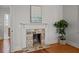 Cozy fireplace with exposed brick, white mantel and hardwood floors at 34 Pinckney St, Charleston, SC 29401