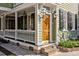 Beautiful front door with sidelights, lanterns, white trim and brick walkway at 34 Pinckney St, Charleston, SC 29401