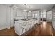 Open-concept kitchen featuring a large island with seating, stainless steel appliances, and modern lighting at 34 Pinckney St, Charleston, SC 29401